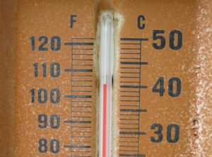 A thermometer shows the temperature above 100 degrees