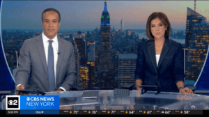 A screengrab of a news broadcast for CBS News New York. The news anchors sit side-by-side, an image of the Empire State Building is behind them.