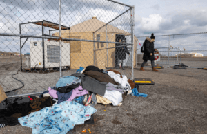 Recently arrived migrants walk from their temporary tent shelters at Floyd Bennett Field, a former airfield in Brooklyn, N.Y., Jan. 04, 2024.